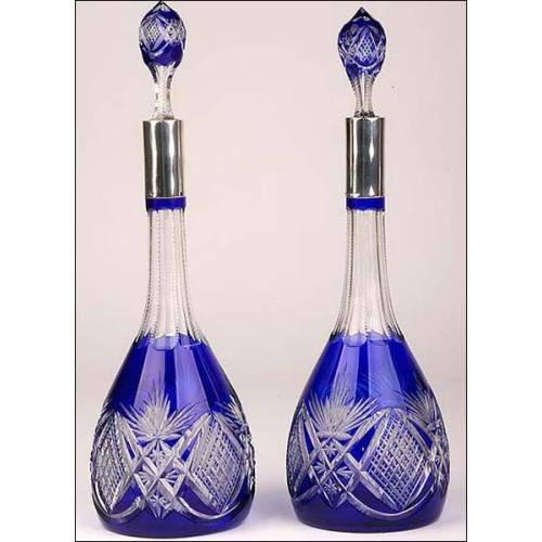 Pair of Bohemian crystal decanters with solid silver mouths.