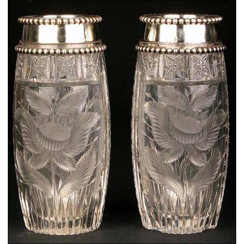 Pair of crystal vases with solid silver rim.