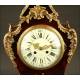 Magnificent mantel clock in wood and tortoise shell. XIX Century.