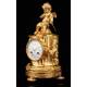 Delicate Mantel Clock in Gilded Bronze with Cupid. France, XIX Century