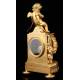 Delicate Mantel Clock in Gilded Bronze with Cupid. France, XIX Century