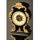 Curious Rococo Mantel Clock in Ebonized Wood and Brass Sconces, ca.1900.