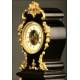 Curious Rococo Mantel Clock in Ebonized Wood and Brass Sconces, ca.1900.