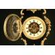 Curious Rococo Mantel Clock in Ebonized Wood and Brass Sconces, ca.1900.